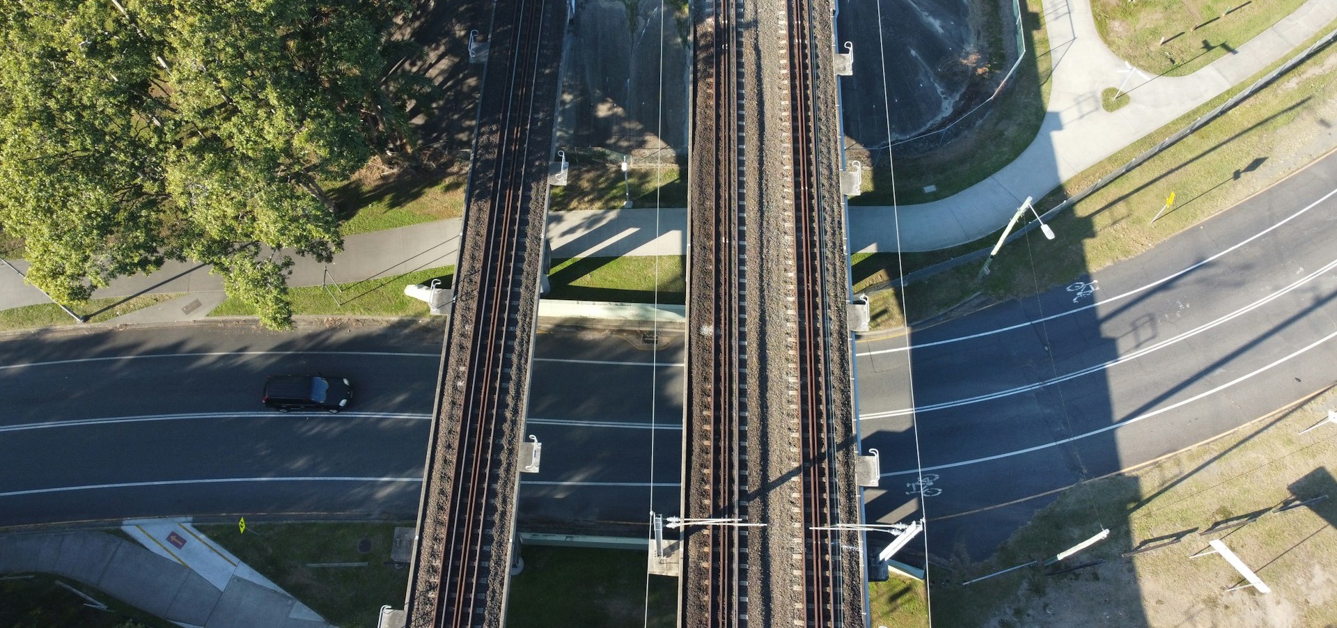 an aerial view of a train track and a street